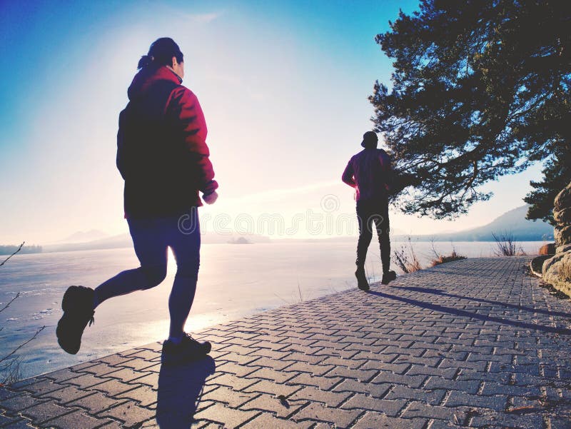 Couple jumping in the sun on a dock of lake. Happy people royalty free stock images Couple jumping in the sun on a dock of lake. Happy people royalty free stock images
