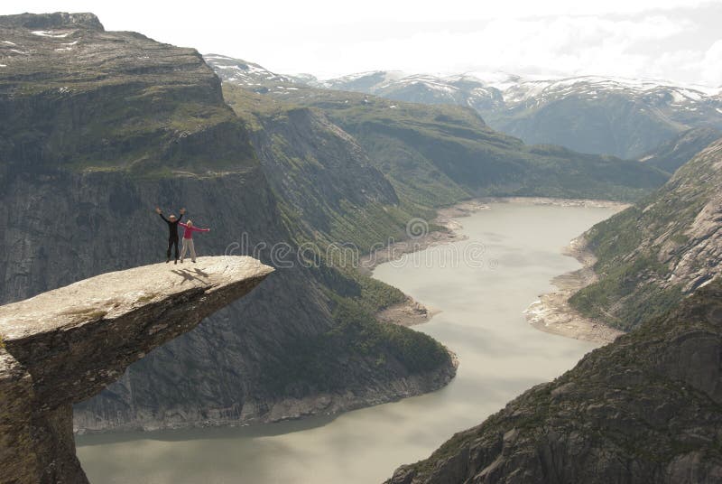 Couple jumping on Troll s Tongue, Norway