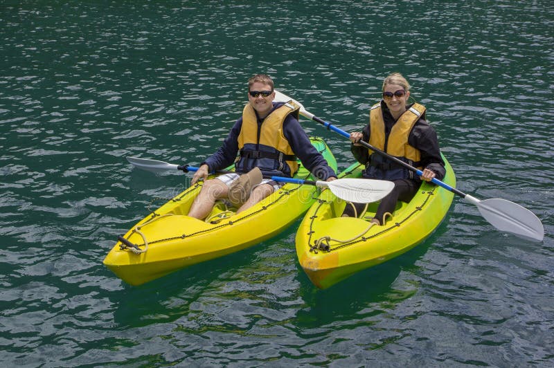 Couple Kayaking on a lake together. Young Couple kayaking on a lake together. Lots of copy space royalty free stock photo