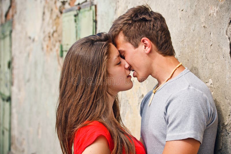 Happy young couple kissing on the city street. Happy embracing couple stock images, royalty-free photos and pictures