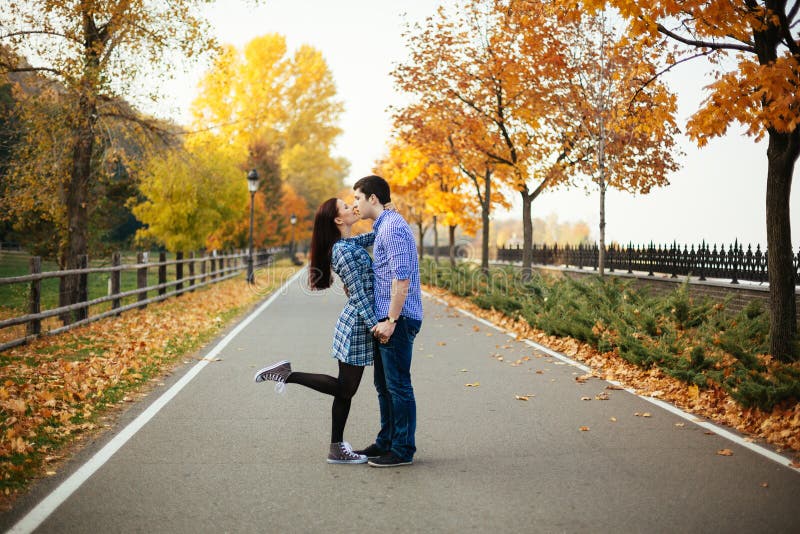 Couple kissing in autumn park stock photos Couple kissing in autumn park stock photos