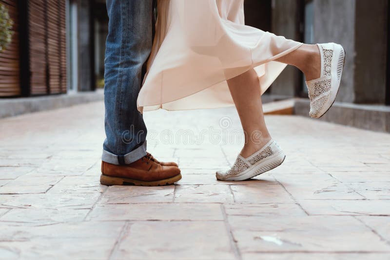The couple kissing, Couples foots stay at the street royalty free stock images The couple kissing, Couples foots stay at the street royalty free stock images
