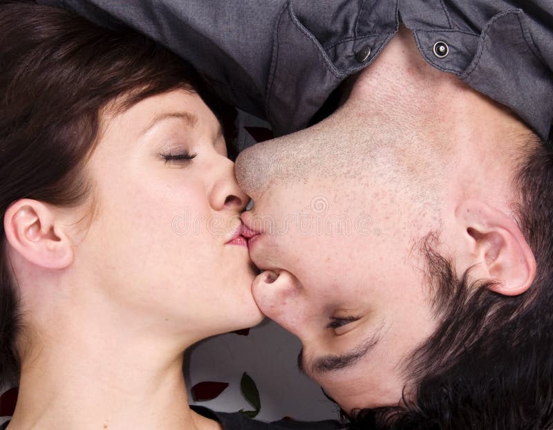 Attractive young couple kissing in romantic pose. Attractive young couple kissing in romantic pose