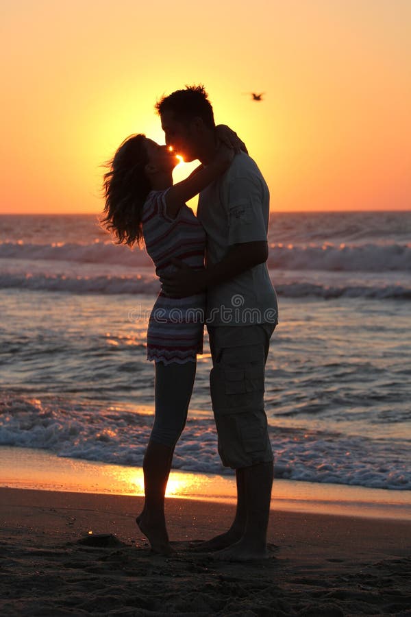 couple kissing at sunset