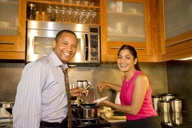 Happy couple standing in kitchen smiling and laughing as they serve soup. Horizontally framed photo. Top smiling cheerful stock images, royalty-free photos and pictures
