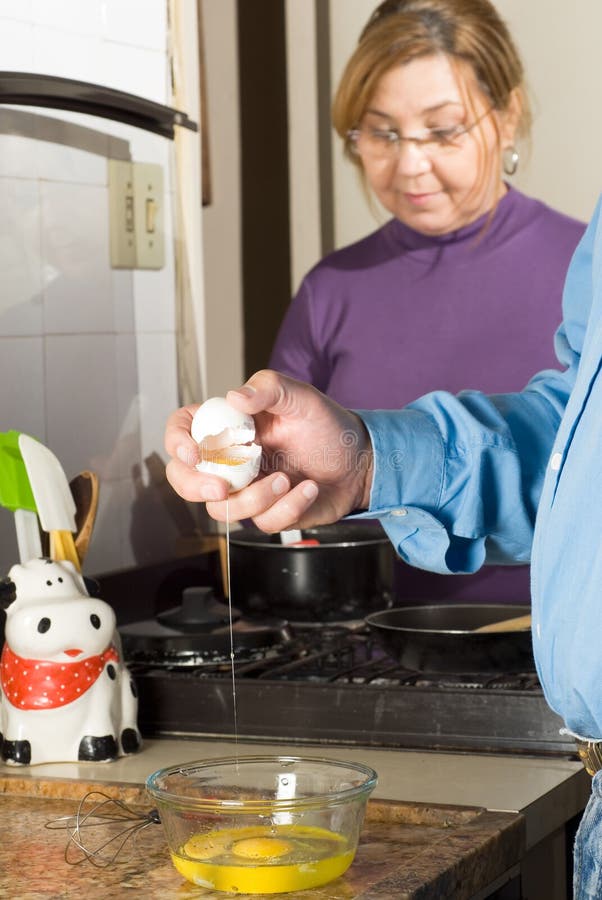 Couple in Kitchen Making Breakfast - vertical