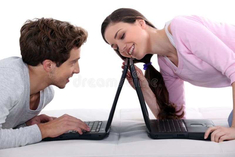 Couple with laptops stock photo