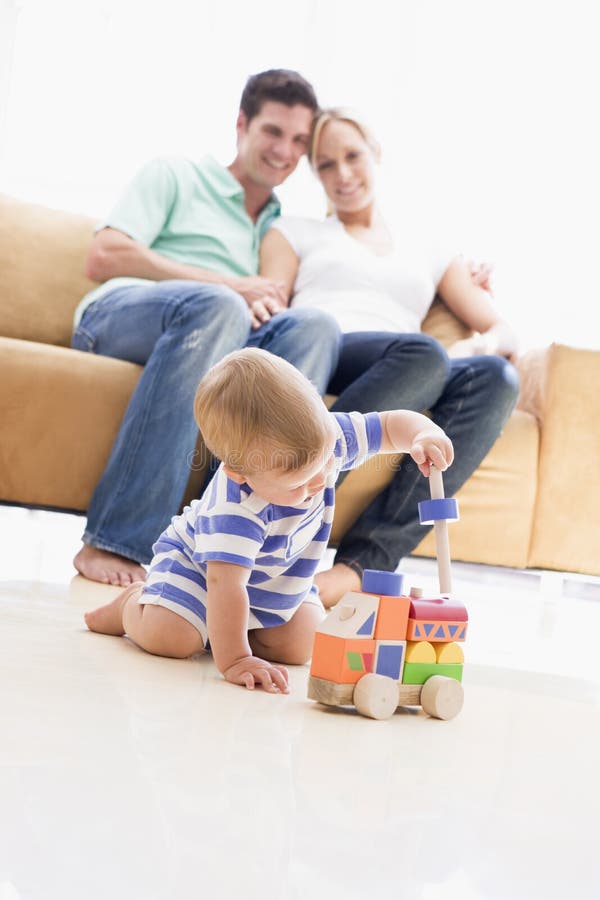 Couple in living room with baby royalty free stock photos Couple in living room with baby royalty free stock photos