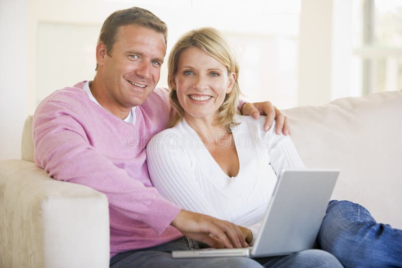 Couple in living room using laptop