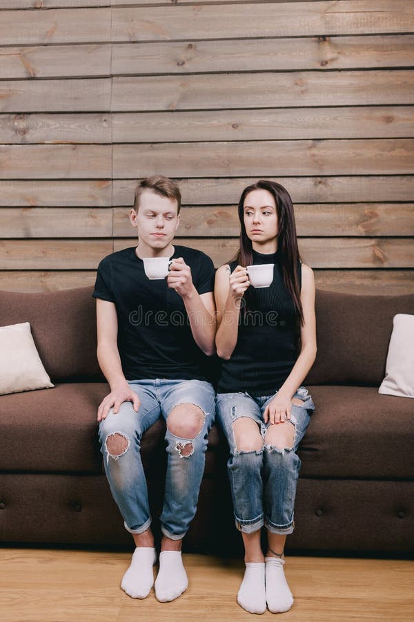 Couple looking at the camera and drink tea