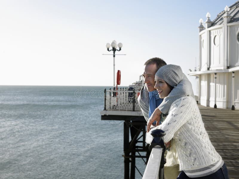 Couple Looking Out at Sea on Pier Stock Photo - Image of enjoyment ...
