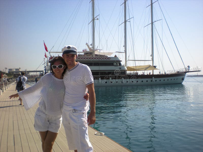 Couple in love on the background of the sea and the yacht. Journey on the yacht of a young couple. royalty free stock photography Couple in love on the background of the sea and the yacht. Journey on the yacht of a young couple. royalty free stock photography