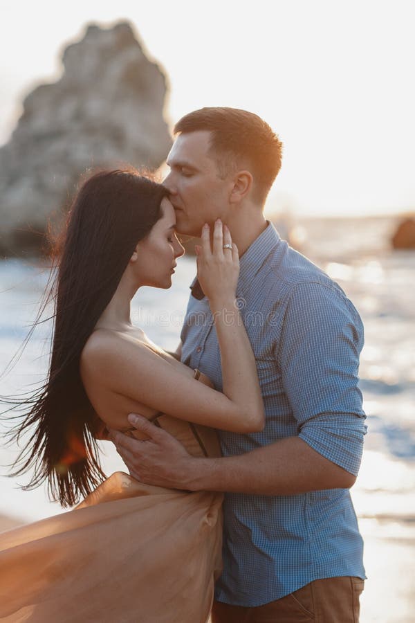 Happy Couple In Love During Honeymoon On A Rocky Beach Near The Blue Ocean Stock Image Image