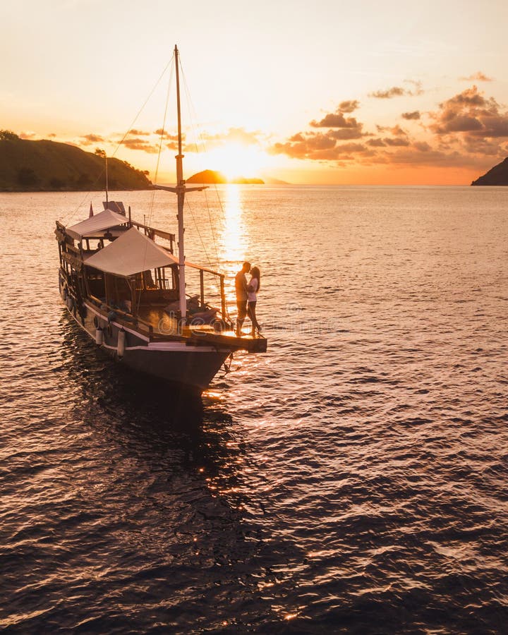 Couple in love enjoying sunset on yacht board stock images Couple in love enjoying sunset on yacht board stock images