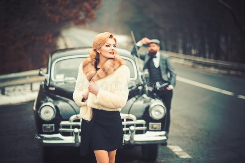 Couple in love on romantic date. Retro collection car and auto repair by mechanic driver. Travel and business trip or royalty free stock photos Couple in love on romantic date. Retro collection car and auto repair by mechanic driver. Travel and business trip or royalty free stock photos