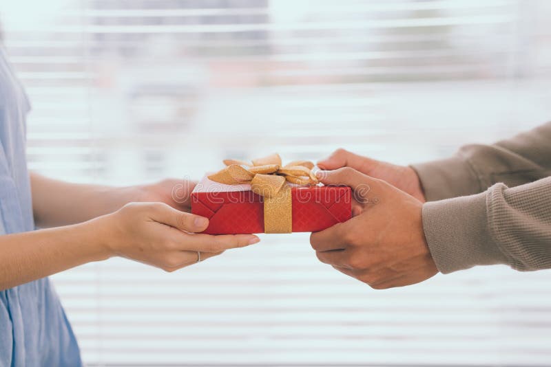 Couple in love. Romantic man giving gift to his girlfriend royalty free stock photo Couple in love. Romantic man giving gift to his girlfriend royalty free stock photo