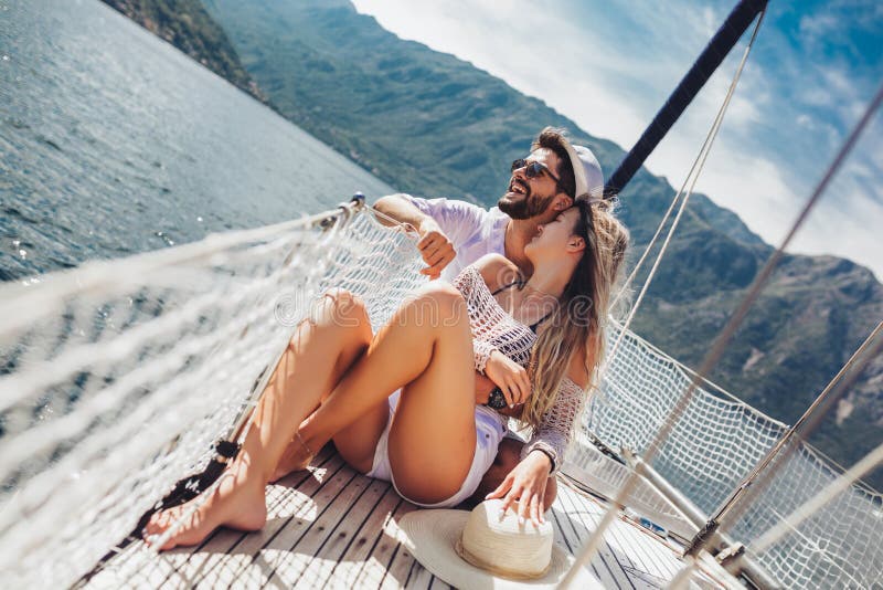 Couple in love on a sail boat in the summer