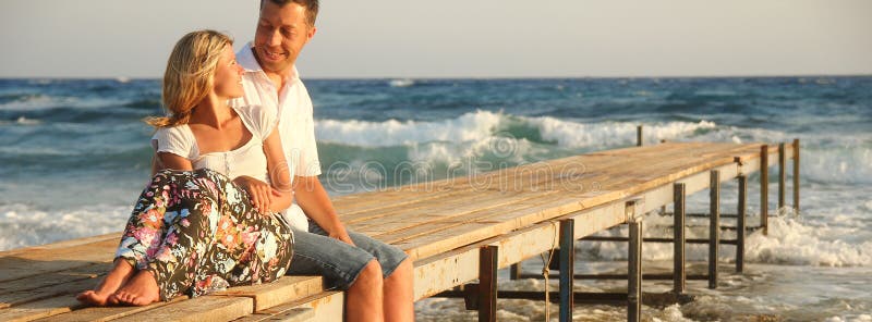 Couple in love on the shore of the sea