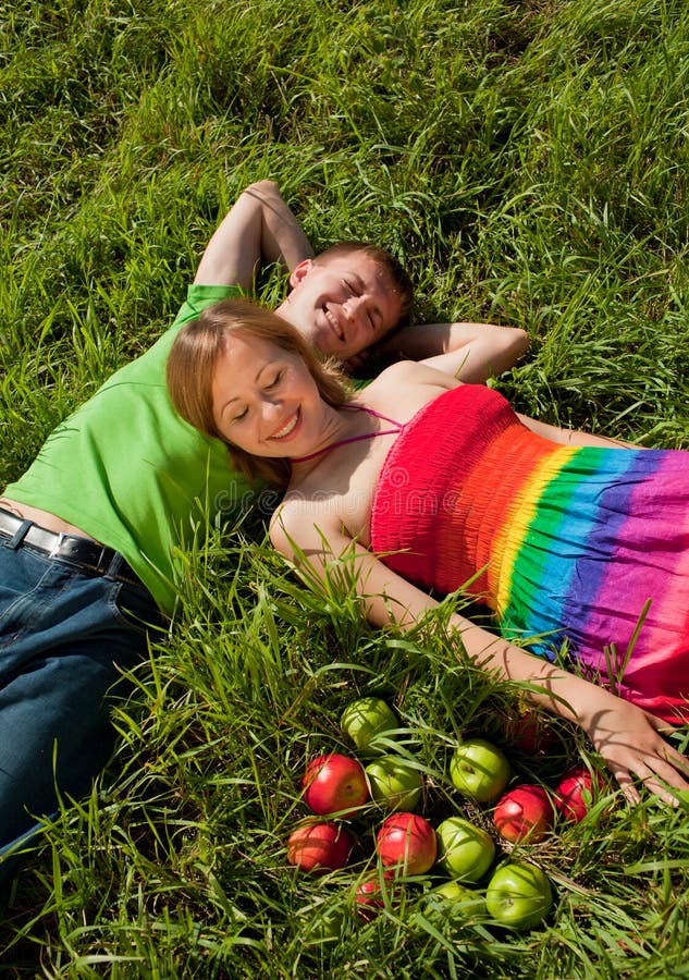 Couple lying on grass and enjoys