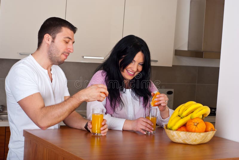 Couple make fresh orange juice royalty free stock image