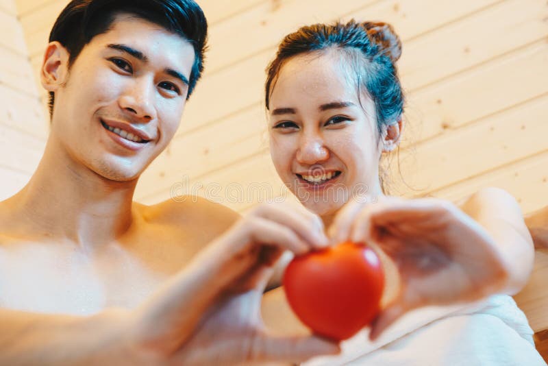 Couple, man and woman were sitting and drinking wine in the sauna stock image Couple, man and woman were sitting and drinking wine in the sauna stock image