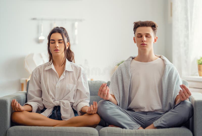 Couple meditating at home