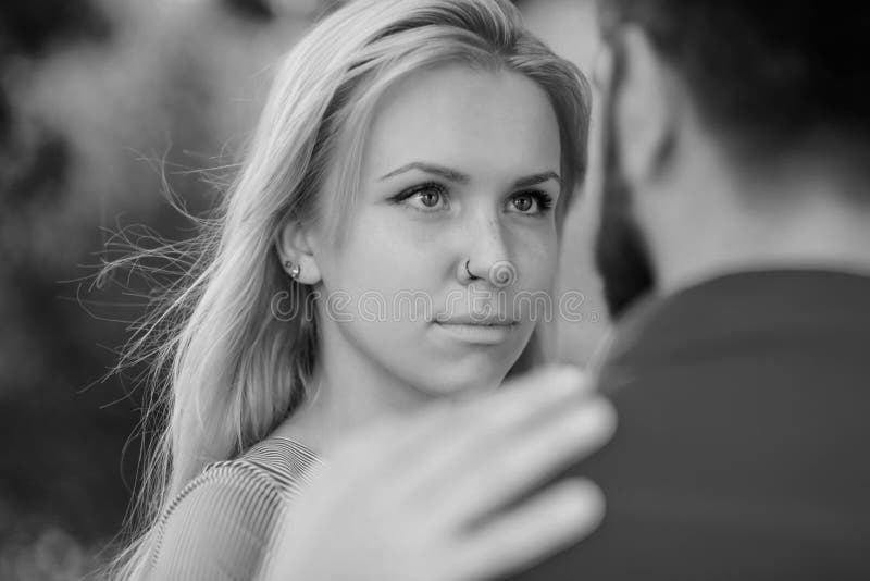 Couple meet on summer day, nature background, defocused, close up. Love, sympathy, dating, eye contact. Girl with calm