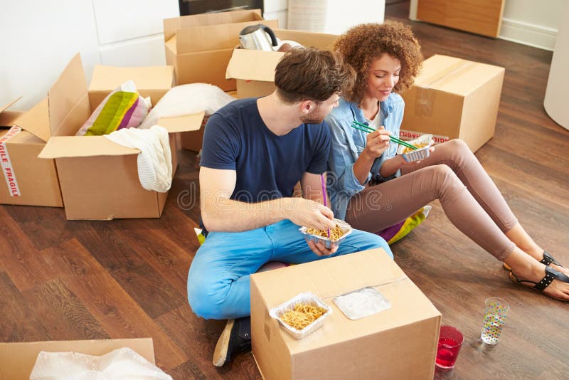 Couple Moving Into New Home Enjoying Takeaway Meal royalty free stock image Couple Moving Into New Home Enjoying Takeaway Meal royalty free stock image