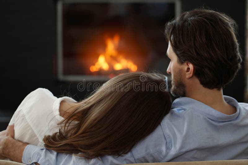 Couple next to the fireplace