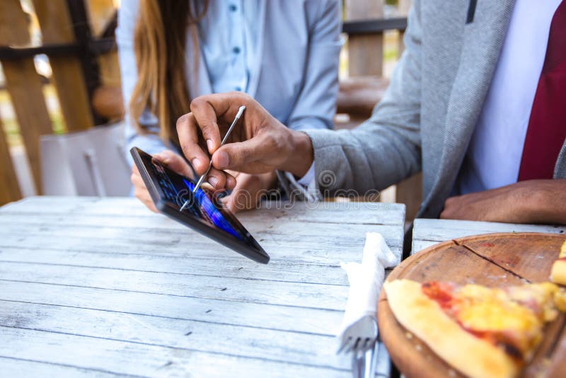 People ordering food on tablet computer in restaurant