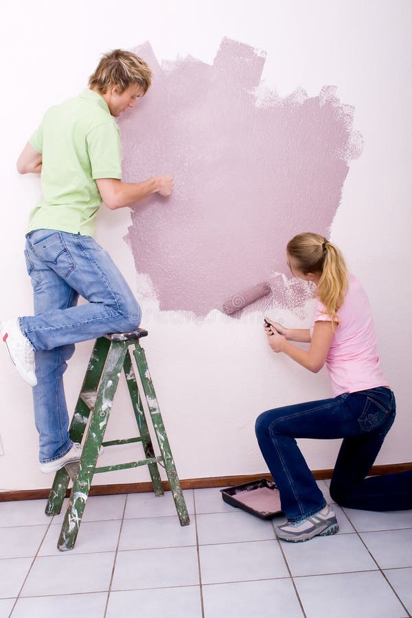Couple painting wall blue. stock photo. Image of lifestyle 6152584
