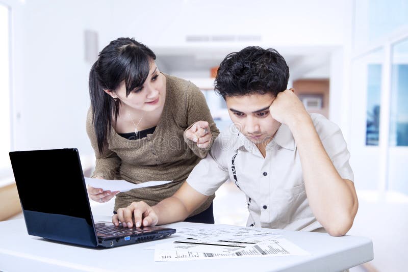 Couple paying bills online stock photos Couple paying bills online stock photos