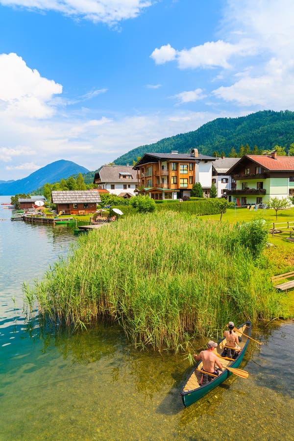 Couple of people in kayak on shore of beautiful Weissensee lake in Alps Mountains, Austria