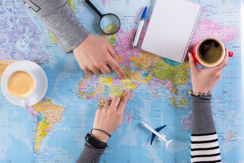 Couple planning trip to Saudi Arabia, point on map stock images Couple planning trip to Saudi Arabia, point on map stock images