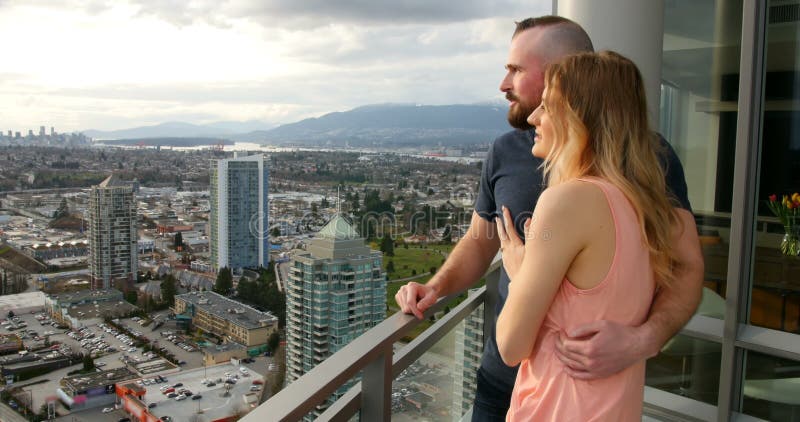 Couple pointing at distance in balcony 4k