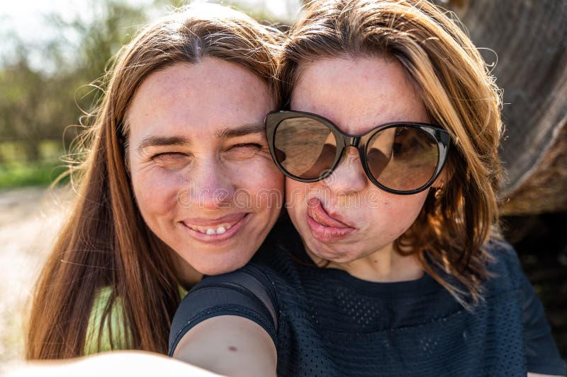 Couple of Pretty Friendly Women Taking a Selfie Making Funny Faces ...