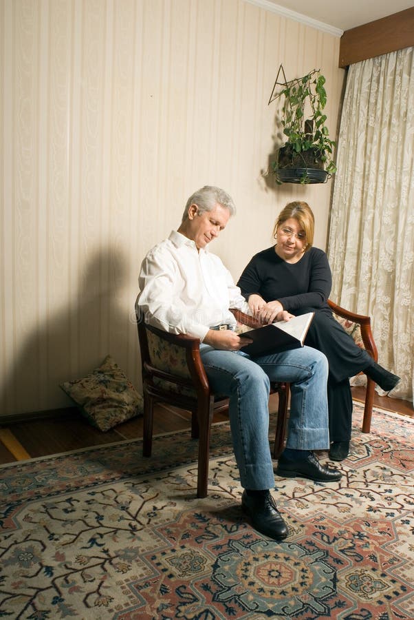 Couple Reading In Living Room-Vertical