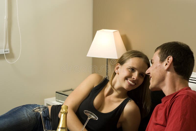 Couple Relax on Bed with Champagne - Horizontal