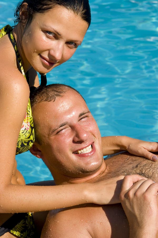 Couple relaxing by the pool