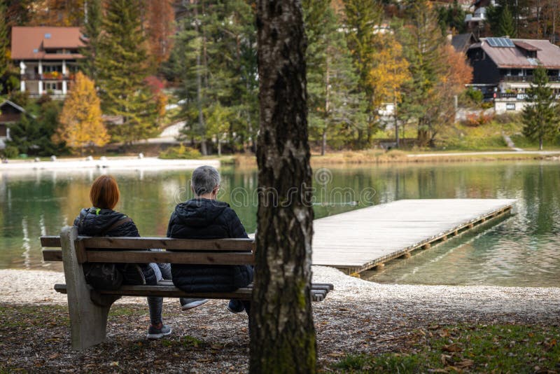 Couple resting on the bench near lake Jasna in Slovenia