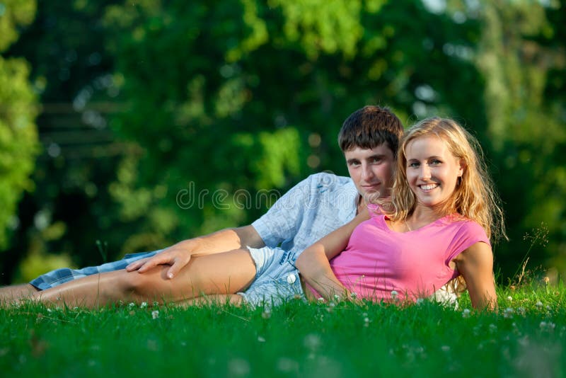 Couple resting on the grass