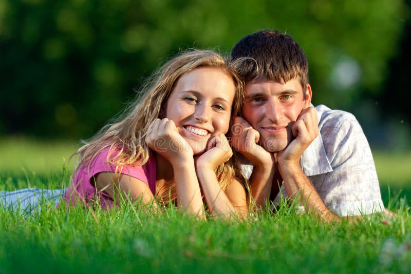 Couple resting on the grass