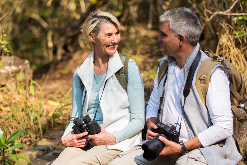 Couple resting mountain valley stock photo
