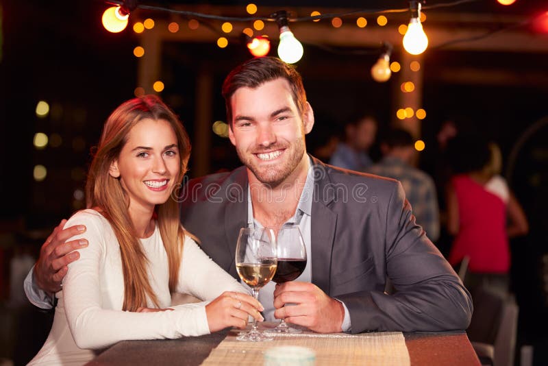 Couple at rooftop party stock photo. Image of camera - 59872320
