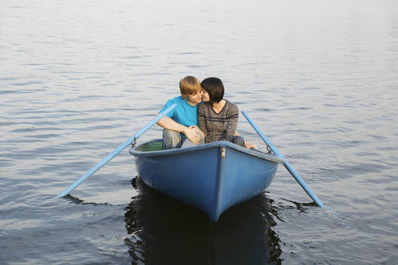 Couple In Rowboat At Lake