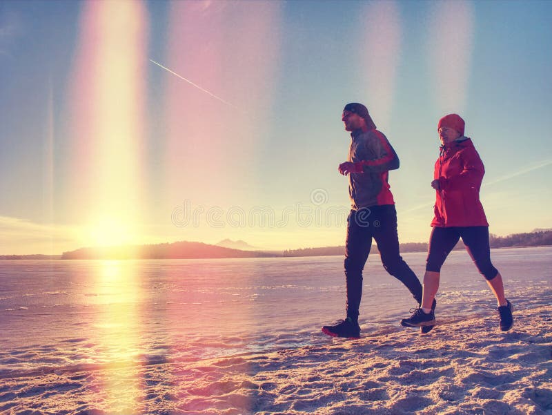 Couple runners running in winter nature stock photography Couple runners running in winter nature stock photography