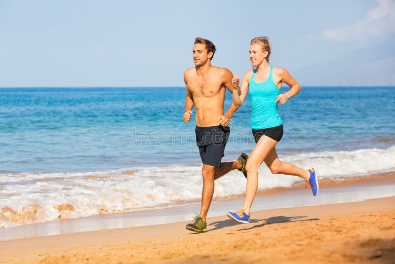 Couple running on the beach stock photos Couple running on the beach stock photos