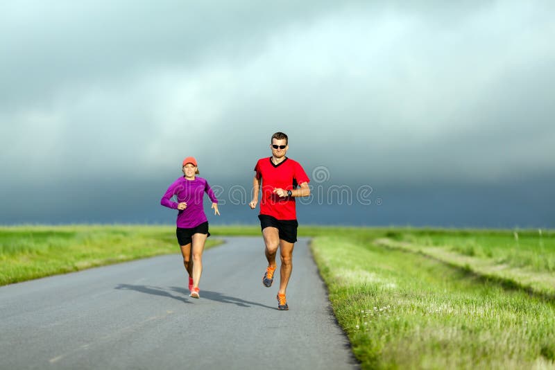 Couple running on country road