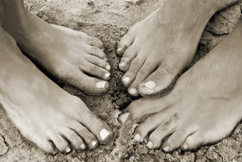 A couple s feet on the beach in the sand