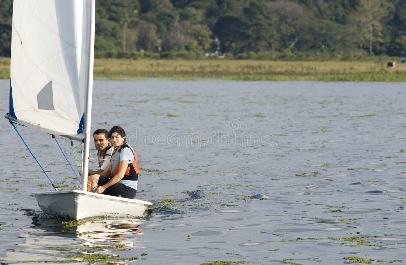 Couple Sailing Across Lake - Horizontal